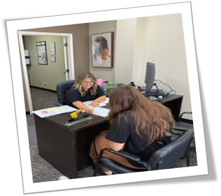 two women working at a desk together